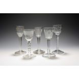 Five wine glasses, mid 18th century, one with a rare oval bucket bowl engraved with grapevine,