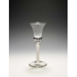 A composite stem wine glass, c.1760-70, the bell bowl with a solid base enclosing two rows of tears,
