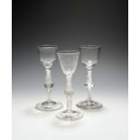 Three small wine glasses, c.1760, two with ogee bowls over multi-series opaque twist stems with