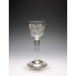 A wine glass of Jacobite type, c.1760, the round funnel bowl engraved with a daffodil and branches