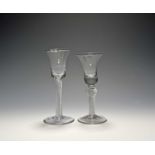 Two wine glasses, c.1740-60, with bell bowls, one with a solid base over an airtwist stem with