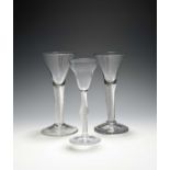 Three wine glasses, c.1750, one with a pan-topped bowl over an airtwist stem with swollen knop,