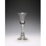 A composite stem wine glass, c.1750, the bell bowl raised on an airtwist stem over annulated collars