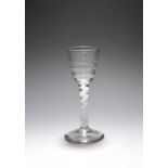 A Lynn wine glass, c.1765, the round funnel bowl moulded with horizontal ribs, raised on a multi-