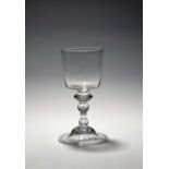 A large baluster wine glass or goblet, c.1730-40, with a generous bucket bowl raised on a baluster