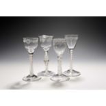 Four small wine glasses, c.1750-60, one with an ogee bowl with everted rim engraved with a band of