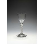 A wine glass, c.1750, the ogee bowl with wrythen moulding, raised on a multi-series opaque twist