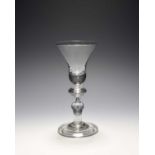 A baluster wine glass, c.1710-20, the bell bowl with a solid base, raised on a stem with annulated