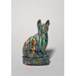 A good creamware Whieldon-type figure of a cat, c.1780, seated on its haunches with head turned to