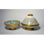 A Moroccan pottery tagine and cover, 19th/20th century, decorated with bold geometric designs in