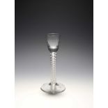 A cordial glass, c.1760-70, the small bowl moulded with vertical flutes, raised on a thick stem with