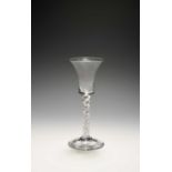 A mixed twist wine glass, c.1750, the bell bowl raised on a mixed twist stem of a white opaque