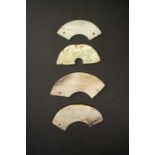 FOUR CHINESE CELADON JADE HUANGNEOLITHIC AND LATEREach formed as a curved segment, pierced with