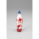 A CHINESE RED OVERLAY GLASS SNUFF BOTTLE1780-1850With a slender milky-white body overlaid with a