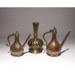 TWO OTTOMAN BRASS EWERS AND A VASE 17TH/18TH CENTURYThe pear-shaped ewers finely engraved with