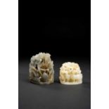 TWO CHINESE RETICULATED JADE HAT FINIALSPROBABLY QING DYNASTYThe larger in a greyish stone, carved