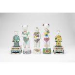 FIVE CHINESE FAMILLE ROSE MODELS OF STANDING BOYS AND TWO STANDS18TH CENTURYThe boys standing