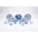 A COLLECTION OF CHINESE BLUE AND WHITE CUPS AND SAUCERS18TH CENTURYComprising: a pair of moulded tea
