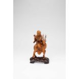 A CHINESE BOXWOOD CARVING OF SHOULAO RIDING A SPOTTY DEERLATE QING DYNASTYThe God sits wearing