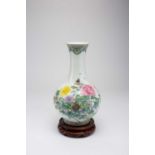 A CHINESE FAMILLE ROSE ‘FLOWERS OF THE FOUR SEASONS’ VASE20TH CENTURYThe bottle-shaped body with a