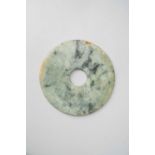 A CHINESE JADE DISC, BIPROBABLY QING DYNASTYThe pale celadon mottled stone with dark green and brown