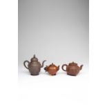 THREE CHINESE YIXING TEAPOTS AND COVERS18TH AND 19TH CENTURYOne in a darker clay with a rope twist