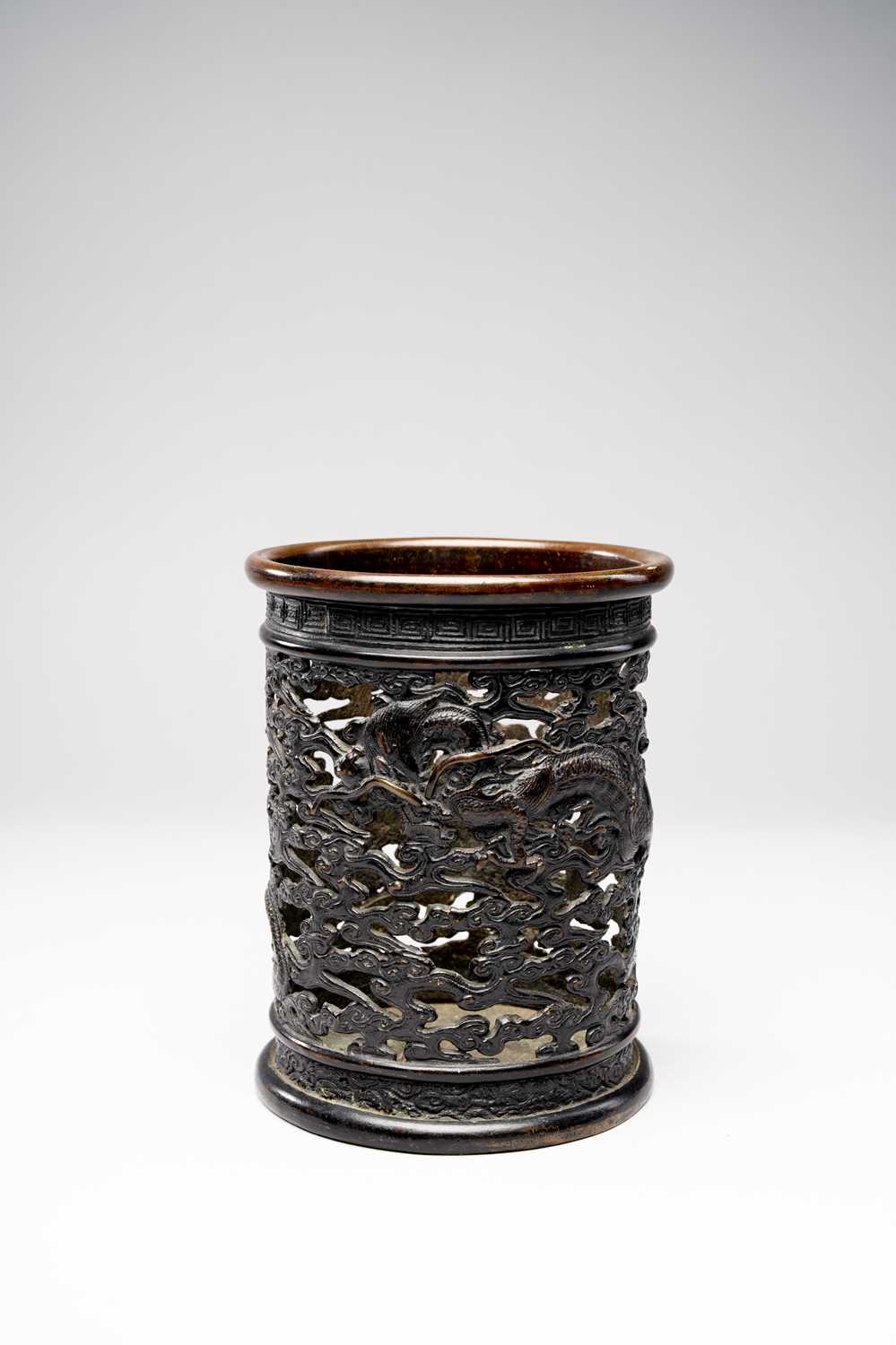 A CHINESE BRONZE RETICULATED BRUSHPOT, BITONG17TH CENTURYThe cylindrical body cast with two