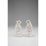 A PAIR OF CHINESE ROCK CRYSTAL MODELS OF PARROTSLATE QING DYNASTYStanding on rocks and holding