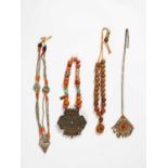 FOUR CHINESE AND TIBETAN NECKLACES19TH AND 20TH CENTURYVariously decorated and carved from a nut and
