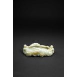 A CHINESE CELADON JADE 'BOYS' BRUSHWASHERQING DYNASTY OR LATERFormed as a large lotus leaf,