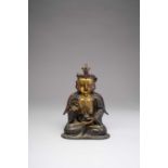 A CHINESE PARCEL-GILT BRONZE FIGURE OF GUANYIN17TH CENTURYThe bodhisattva seated in dhyanasana