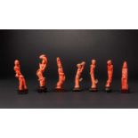 SEVEN CHINESE CORAL CARVINGS OF FEMALE DEITIES AND A BOYQING DYNASTYEach carved as a slender figure,