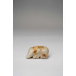 † †A CHINESE GREY AND RUSSET JADE CARVING OF AN ELEPHANTMING/QING DYNASTYThe recumbent beast with