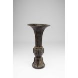 A CHINESE BRONZE ARCHAISTIC GU-SHAPE VASE17TH CENTURYThe central section and base cast with taotie