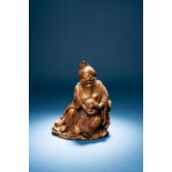 † †A CHINESE BAMBOO CARVING OF DONGFANG SHUO18TH CENTURYThe smiling God sits comfortably on rocks,
