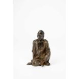 † †A RARE CHINESE BRONZE FIGURE OF A SEATED LUOHANYUAN DYNASTYWell modelled with his head turned