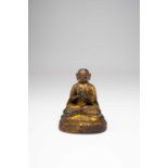 A TIBETAN GILT-BRONZE FIGURE OF A LAMA17TH/18TH CENTURYHe sits in dhyanasana with his hands raised