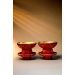 A RARE PAIR OF CHINESE IMPERIAL CARVED CINNABAR LACQUER ‘DRAGON’ BOWLS AND STANDS