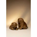 A PAIR OF JAPANESE BRONZE TOKYO SCHOOL OKIMONO OF PUPPIESMEIJI OR TAISHO, 19TH OR 20TH CENTURY The