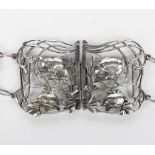 An Art Nouveau silver belt by William Comyns, the two piece buckle pierced and cast with stylised
