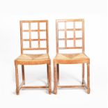 A pair of Heal's limed oak chairs, 1925, open trellis back, drop in rush seats, on turned front