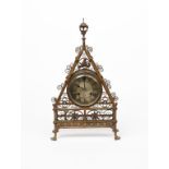 A large Reformed Gothic brass mantel clock designed by Bruce Talbert, probably by Cox & Co or