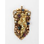 A yellow metal pendant necklace, cast with a reclining putti figure, amongst flowers, set with