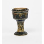 An early Martin Brothers stoneware egg cup by Robert Wallace Martin, incised with geometric bands in