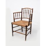 A rush seated ash armchair, with turned bobbin back and arms, unsigned, 81.5cm. high Provenance