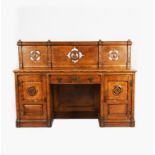 A Reformed Gothic oak desk in the manner of Bruce Talbert, rectangular top on hinged cupboards and