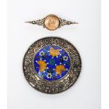 A silver brooch by Winifred Whitside, originally half a buckle, circular with chased band of
