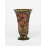 Chrysanthemum/Revived Cornflower a tall James Macintyre footed vase designed by William Moorcroft,