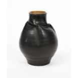 A Martin Brothers stoneware vase, ovoid vase with twisted neck, glazed to the exterior matt black,