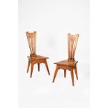 A pair of Liberty & Co oak Wyclif chairs designed by Leonard Wyburd, angular form with drop in